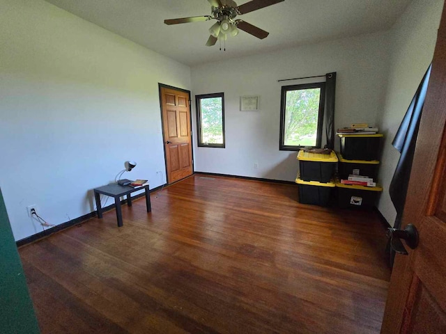 unfurnished room featuring dark hardwood / wood-style flooring and ceiling fan