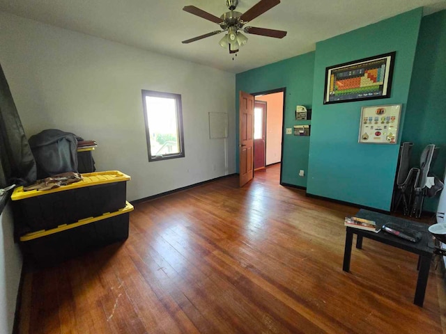 interior space with dark hardwood / wood-style flooring and ceiling fan