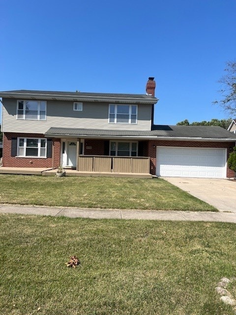 view of front of home with a garage and a front lawn