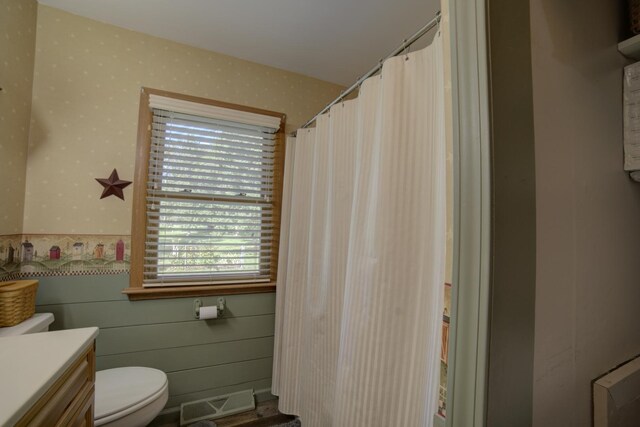 bathroom featuring toilet and vanity