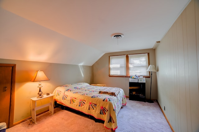 carpeted bedroom with vaulted ceiling