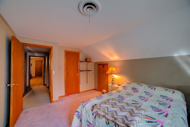 bedroom with carpet flooring and vaulted ceiling