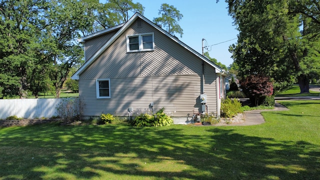 view of side of home featuring a yard