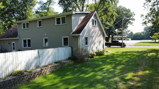 back of property with a lawn