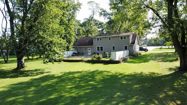 back of house featuring a lawn