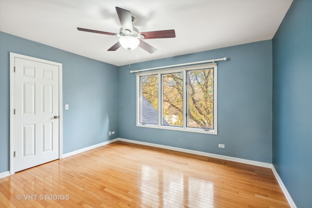 spare room with ceiling fan and wood-type flooring