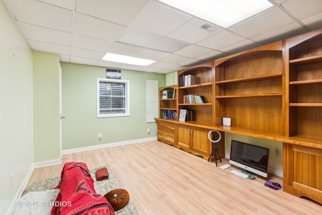 interior space with light hardwood / wood-style flooring and a drop ceiling