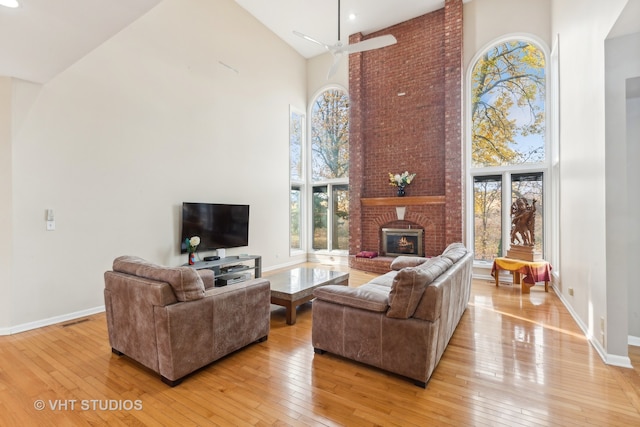 living room featuring light wood-type flooring and high vaulted ceiling