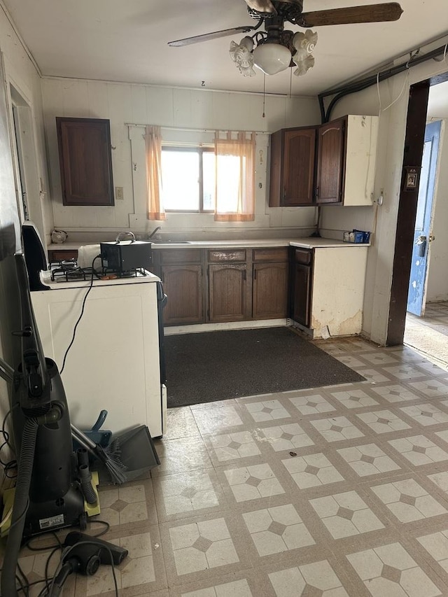 kitchen with light floors, a ceiling fan, and light countertops