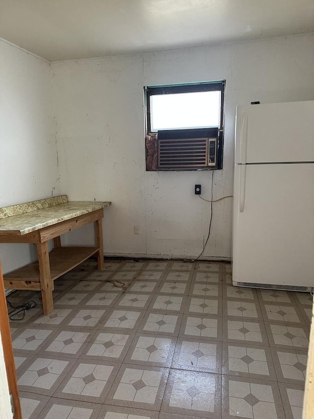unfurnished dining area with cooling unit and light floors
