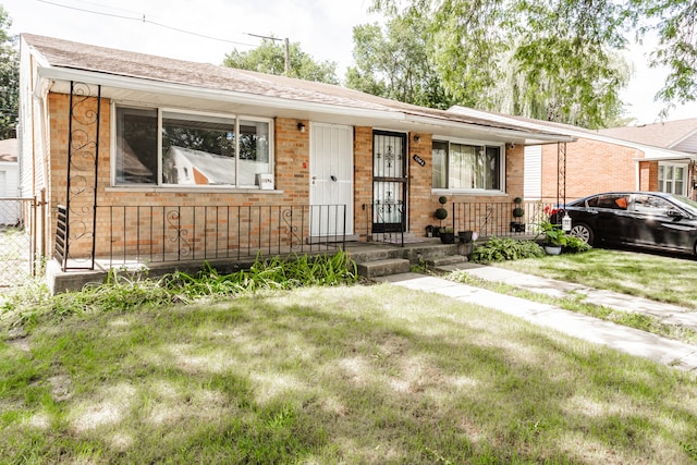 ranch-style house with a porch and a front lawn