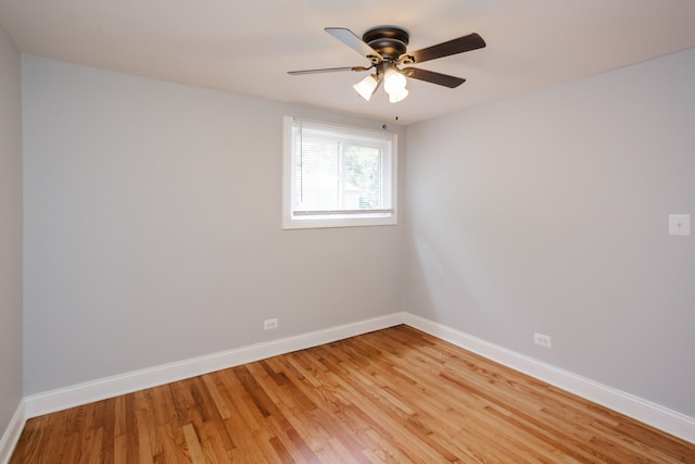 spare room with ceiling fan and light wood-type flooring