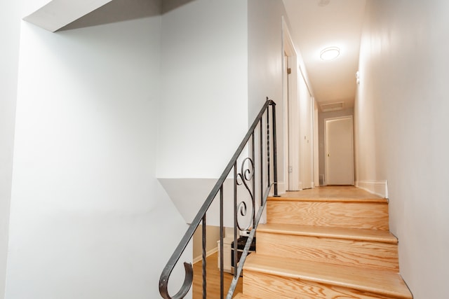 stairs with wood-type flooring