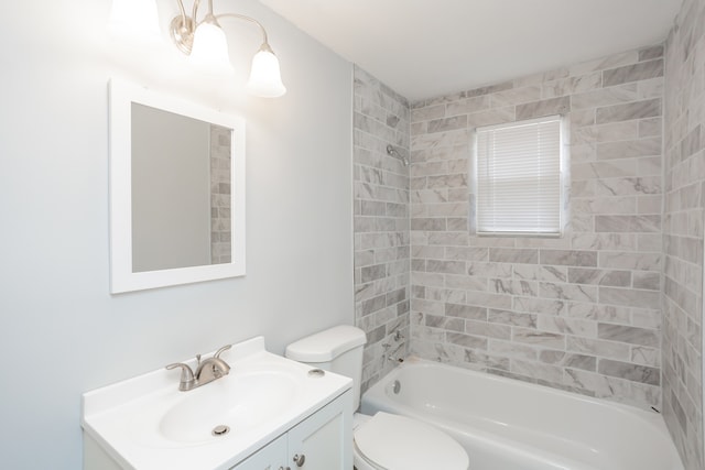 full bathroom with tiled shower / bath, toilet, and vanity