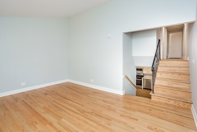 interior space featuring light hardwood / wood-style flooring and vaulted ceiling