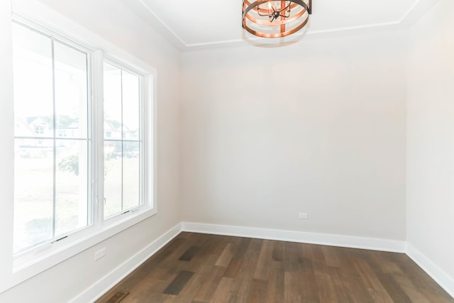 empty room with dark wood-style flooring and baseboards