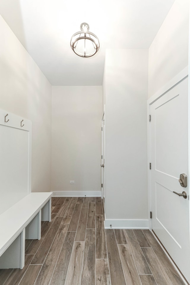 mudroom with wood tiled floor and baseboards