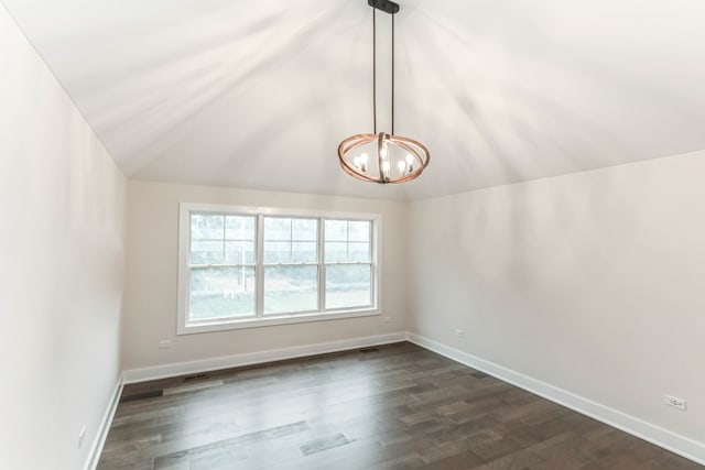 spare room with lofted ceiling, dark wood-style flooring, and baseboards