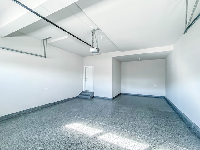 garage featuring baseboards and a garage door opener