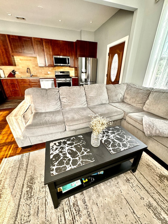 living room with sink and hardwood / wood-style floors