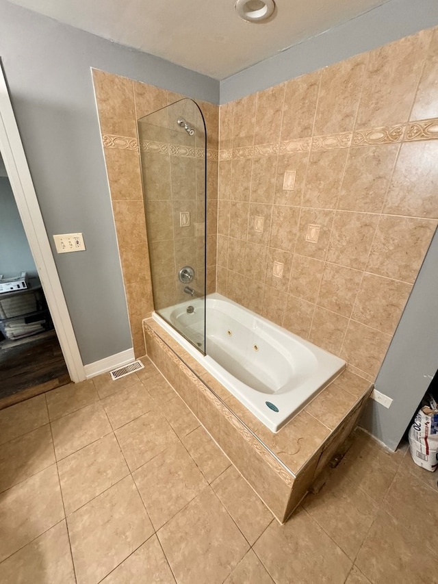 bathroom featuring tile patterned flooring and tiled shower / bath