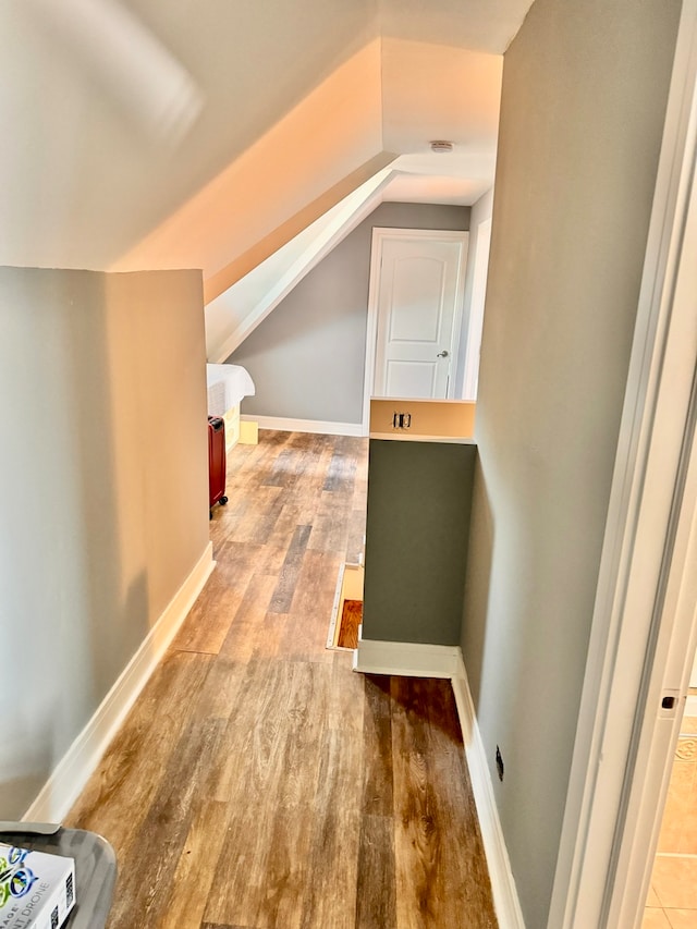 bonus room featuring vaulted ceiling and light hardwood / wood-style floors