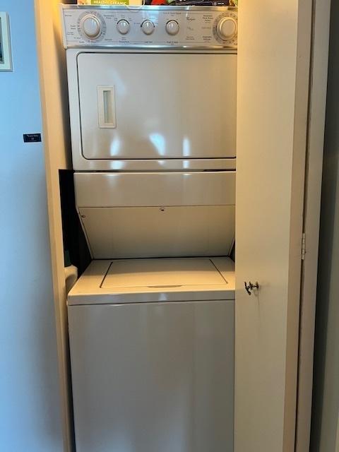 laundry room featuring stacked washer and clothes dryer