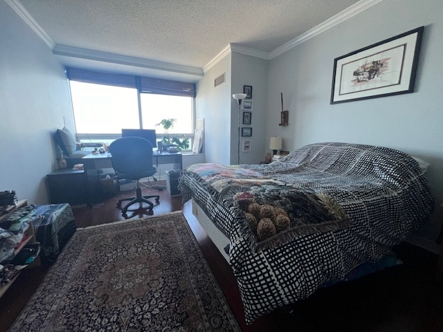 bedroom with ornamental molding and a textured ceiling