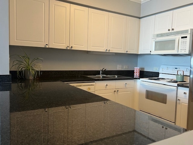 kitchen with sink, dark stone counters, white appliances, white cabinets, and ornamental molding