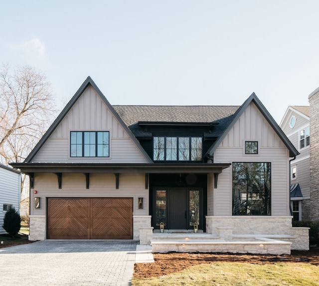 modern inspired farmhouse featuring a garage