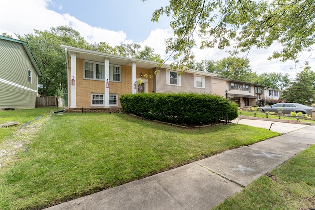 raised ranch with a front yard