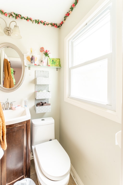 bathroom with toilet, vanity, and tile patterned floors