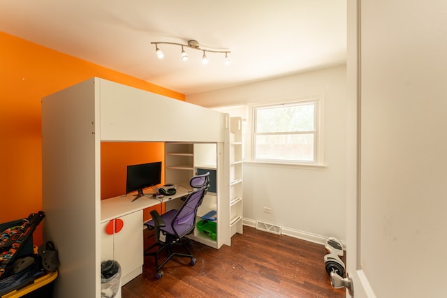 office area with rail lighting and dark hardwood / wood-style floors