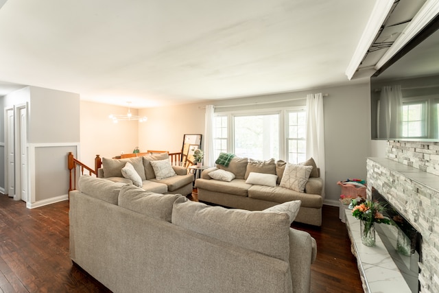 living room featuring dark hardwood / wood-style floors, plenty of natural light, and a fireplace