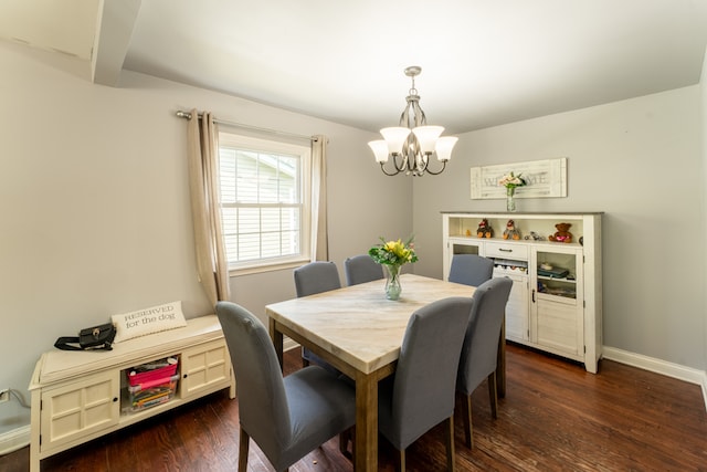 dining space featuring an inviting chandelier and dark hardwood / wood-style floors