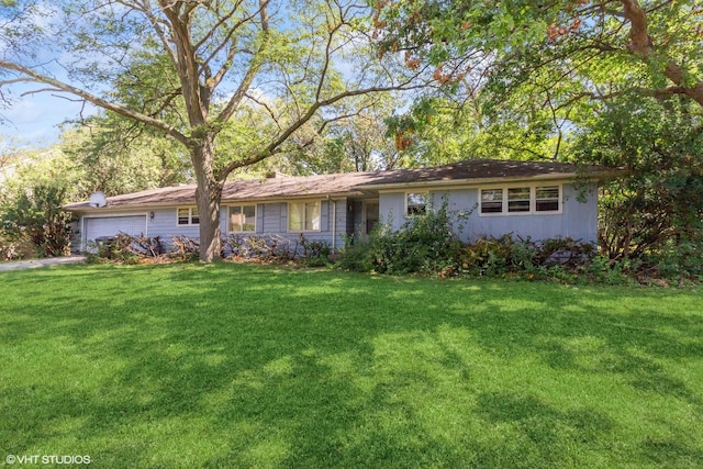 ranch-style house with a garage and a front yard