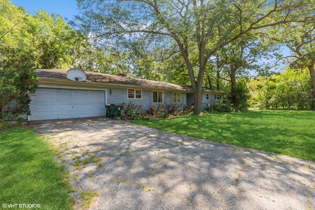 ranch-style home with a garage and a front lawn