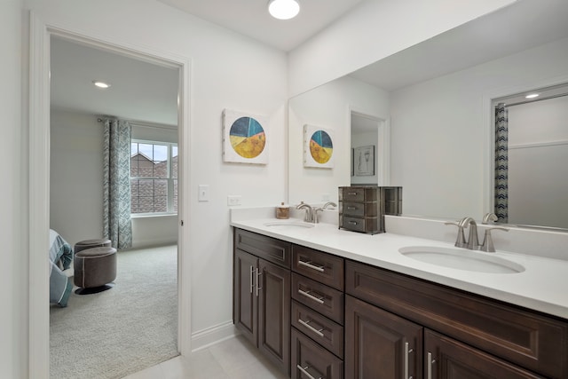 bathroom with dual bowl vanity and tile patterned flooring