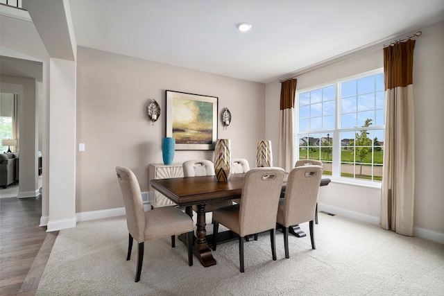 dining space with hardwood / wood-style flooring