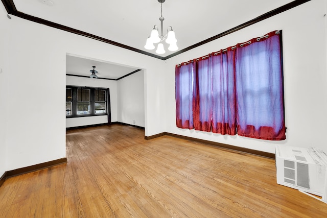 empty room featuring light hardwood / wood-style flooring and ceiling fan with notable chandelier