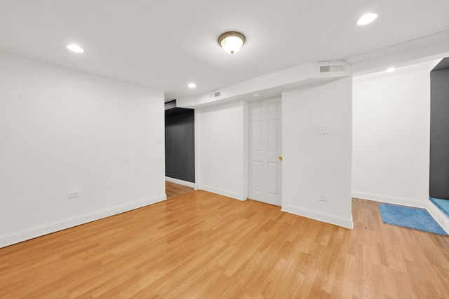 basement with light hardwood / wood-style floors