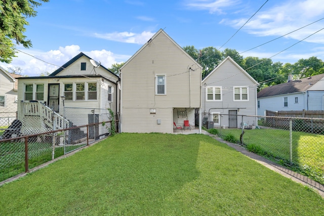 back of property featuring a lawn