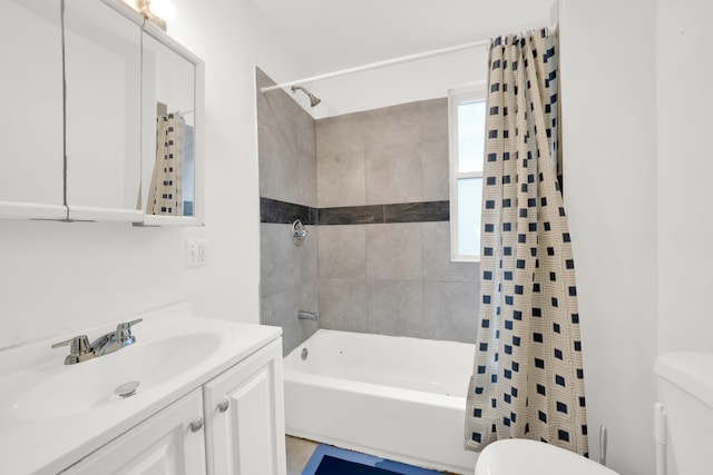 full bathroom featuring toilet, shower / bath combo with shower curtain, and vanity