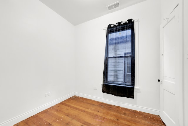 unfurnished room with hardwood / wood-style flooring