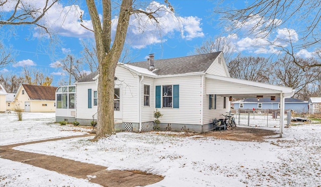 view of front of house with a carport and a sunroom