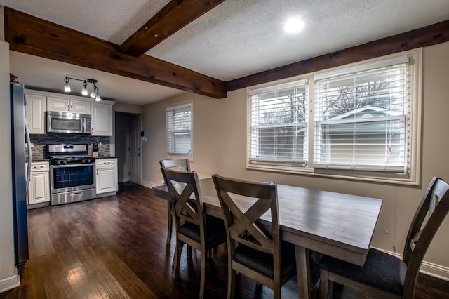 dining room featuring dark hardwood / wood-style flooring, a textured ceiling, and beamed ceiling