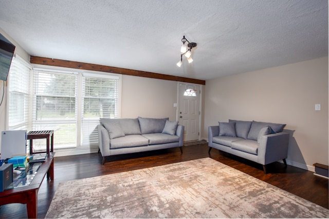 living room featuring a textured ceiling and dark wood-type flooring