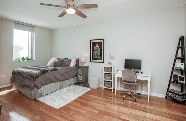 bedroom with ceiling fan and light hardwood / wood-style floors