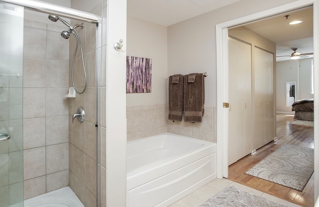 bathroom with ceiling fan, independent shower and bath, and hardwood / wood-style flooring