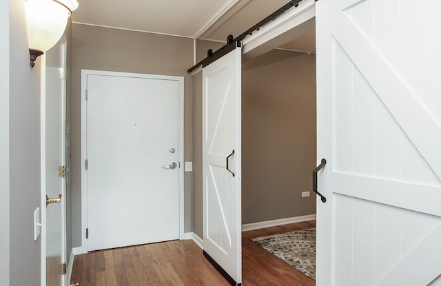 interior space featuring light hardwood / wood-style floors and a barn door